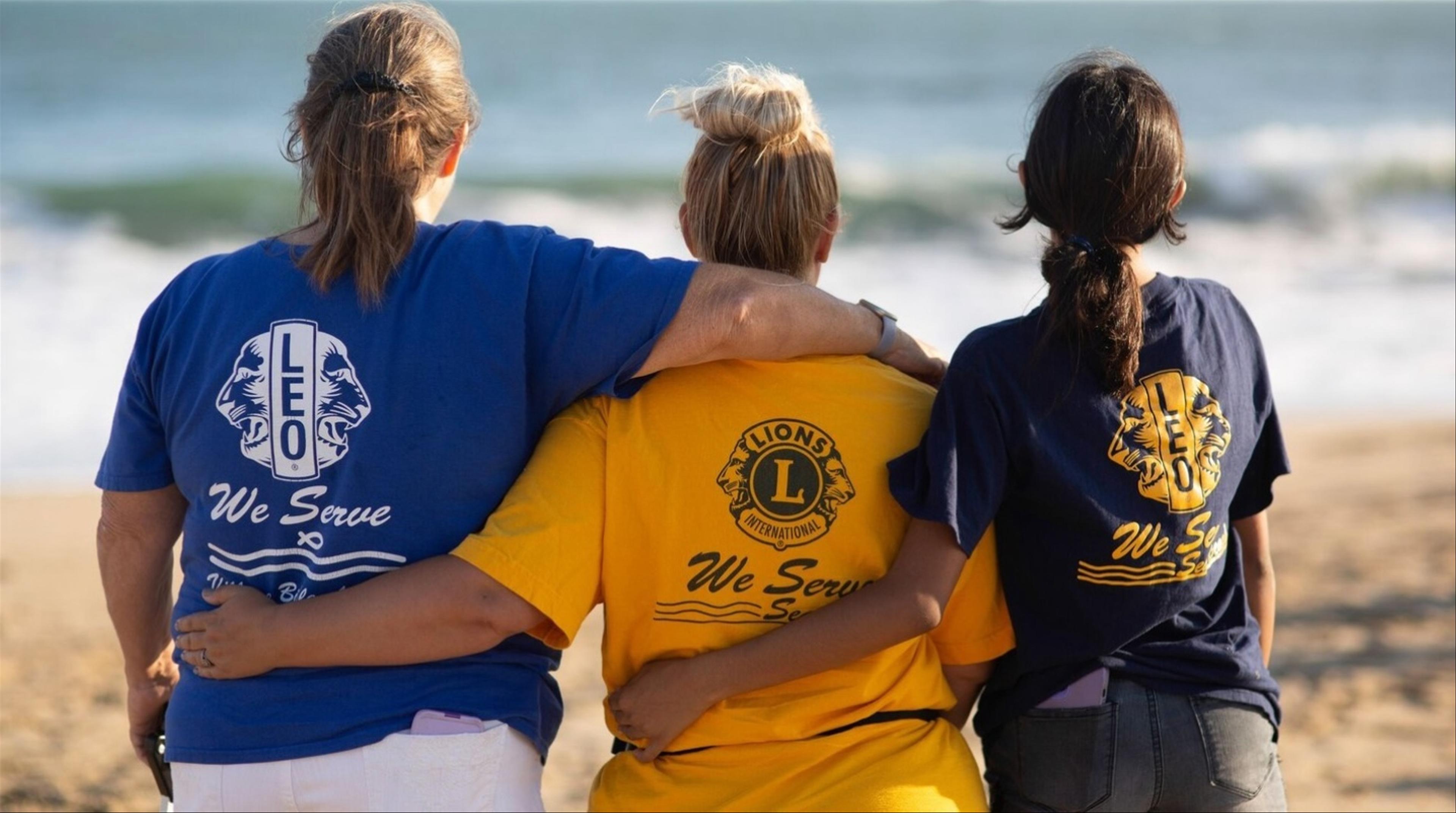 Picture of three Lions Club members looking at the ocean